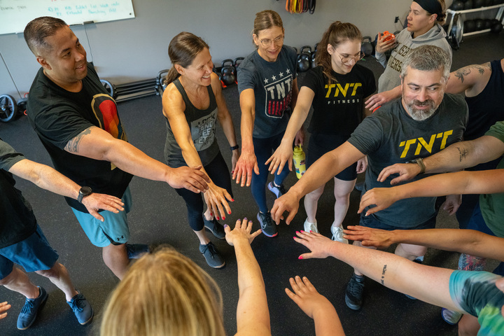 TNT Fitness coach guiding a client through a training session