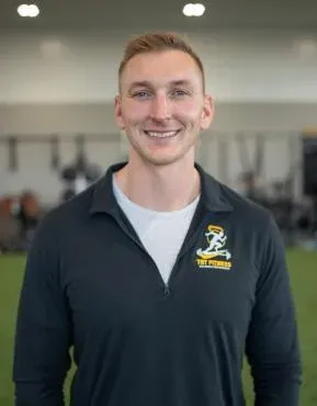 TNT Fitness coach on the training floor at the Menasha gym