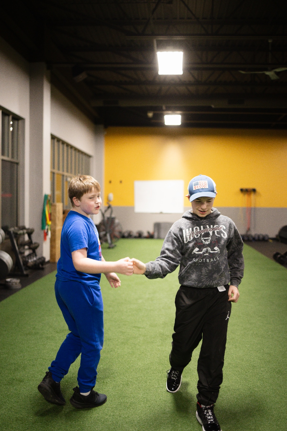 Young person fist bump at TNT Fitness