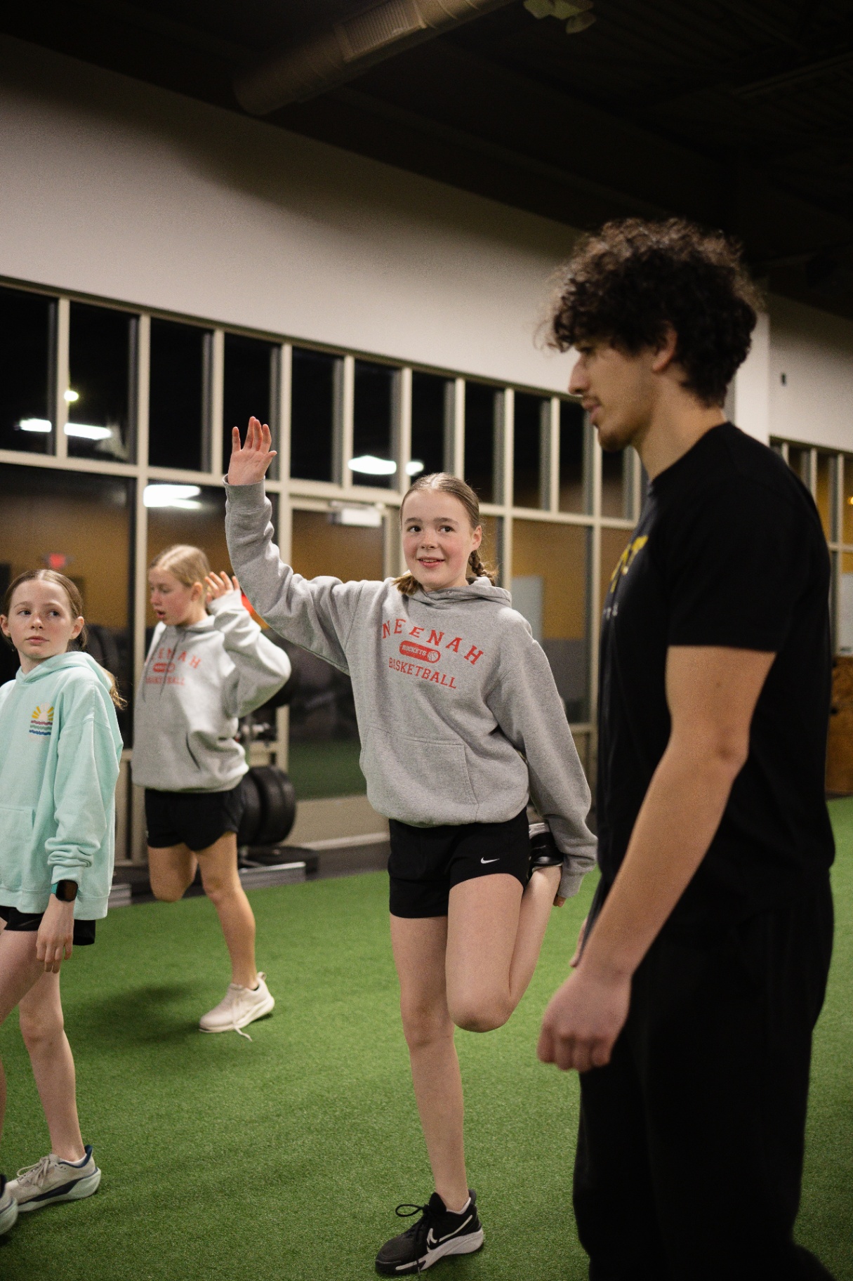 Young person carrying a plate at TNT Fitness